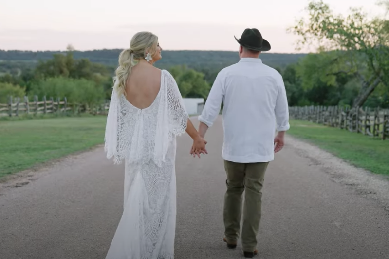 Contigo Wedding Couple holding hands after saying I do at the Bluff