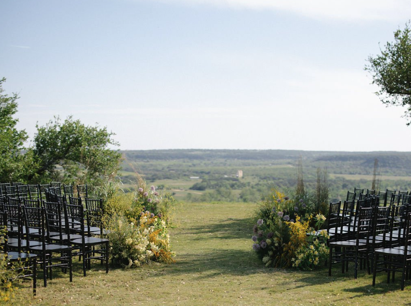 Wedding on the bluff with soft florals and black chairs