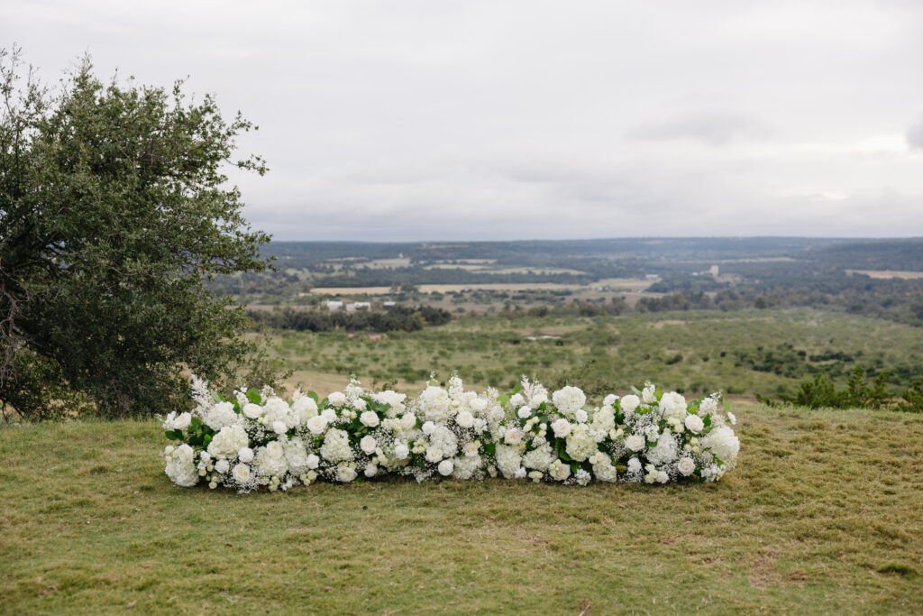 White florals at the bluff for a classic and chic Hill Country wedding.